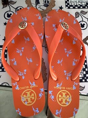 Tory Burch Orange Flip Flops with Pale Blue Floral Print and Gold Logo